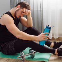 young man making sport exercises at home